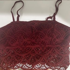 Red lace crop top with built in bra and spaghetti straps. Adjustable. Size XS